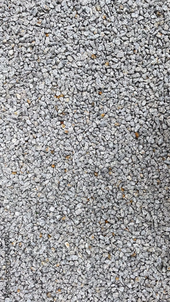 Fototapeta Granite stone texture background with uniformly crushed grains suitable for flooring, symbolizing durability,
