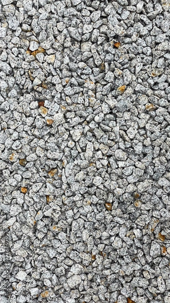 Fototapeta Granite stone texture background with uniformly crushed grains suitable for flooring, symbolizing durability,