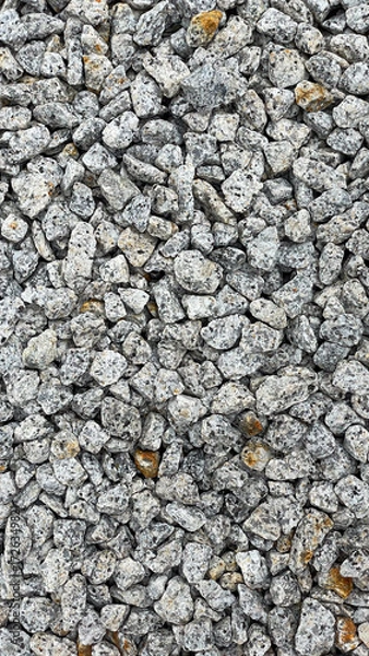 Fototapeta Granite stone texture background with uniformly crushed grains suitable for flooring, symbolizing durability,