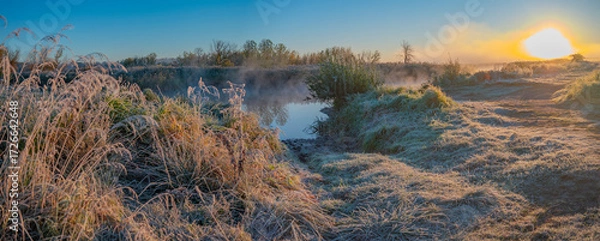 Fototapeta The first frost and fog by the river at dawn
