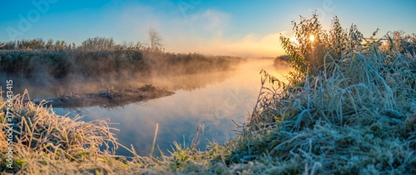 Fototapeta The first frost and fog by the river at dawn