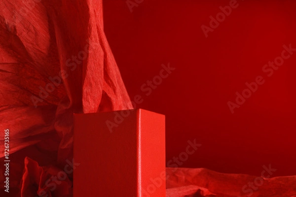 Fototapeta Empty red podium on dramatic red background with crumpled paper