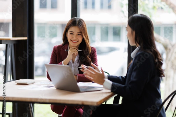 Fototapeta Two asian Business financial, accountant discussing with partner are meeting to audit finance planning sales to meet targets set in next year. stock market concept..
