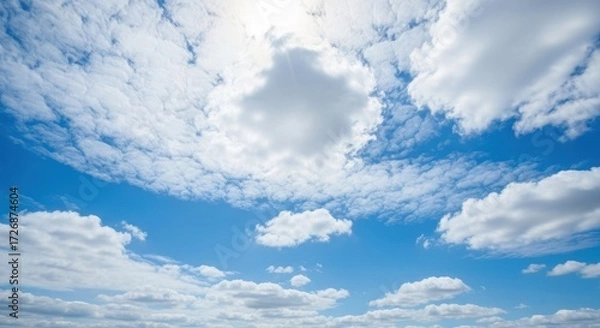 Fototapeta A vast expanse of a vibrant blue sky dotted with puffy white clouds