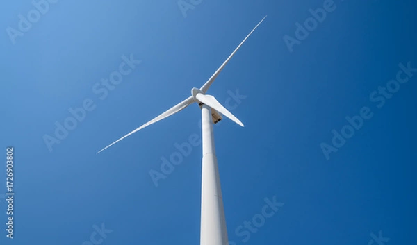 Fototapeta View of a wind farm or wind park with tall wind turbines to generate electricity with copy space. Green energy concept.