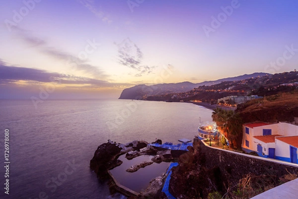 Fototapeta Coastal view near Sao Martinho in Madeira at blue hour just after sunset.