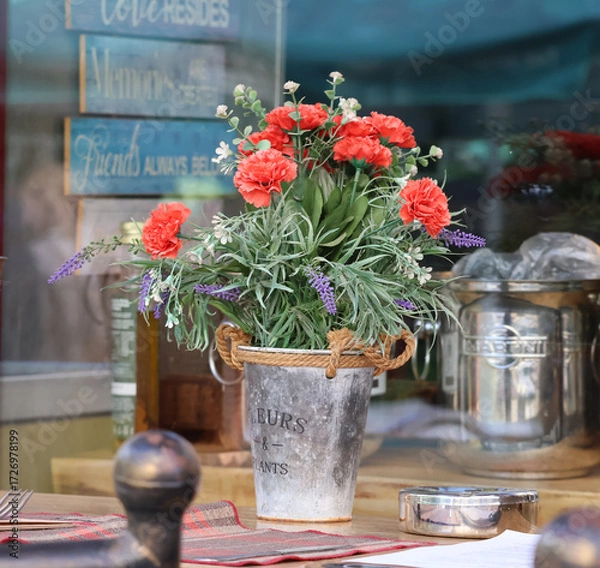 Fototapeta A bouquet of autumn flowers and reflections in the restaurant window.