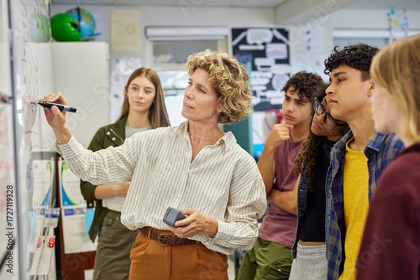 Fototapeta High school teacher giving lesson to multiethnic students
