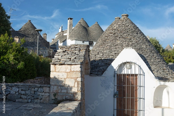 Fototapeta Italy, Apulia, Alberobello, view of the city on a cloudy spring day
