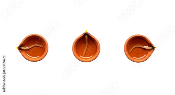 Obraz Set of three diya lamps arranged in a straight line from a top view for festive occasions