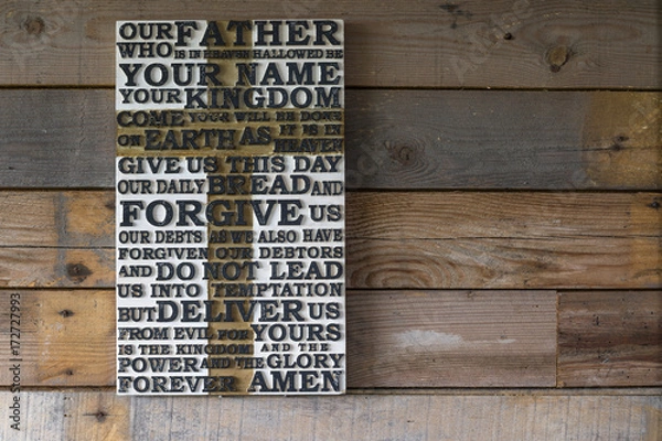 Fototapeta Wooden carved word of the Lord's Prayer on the  shabby wooden  plank  background.