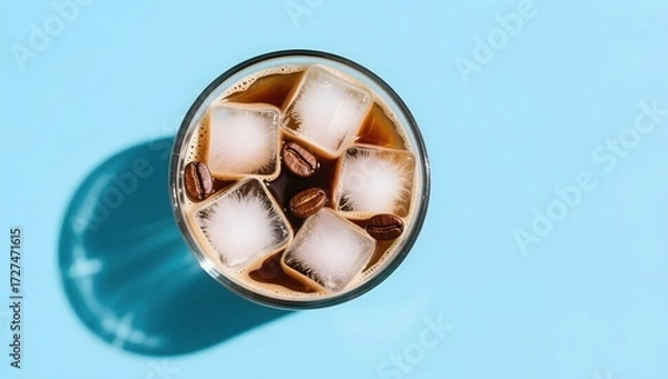 Fototapeta Refreshing Iced Coffee Drink with Ice Cubes and Coffee Beans