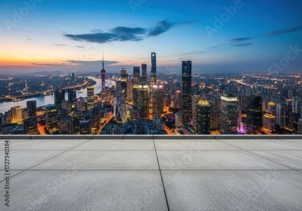 Fototapeta Panoramic view of a modern city skyline at dusk with a river and illuminated skyscrapers, showcasing urban development and city lights