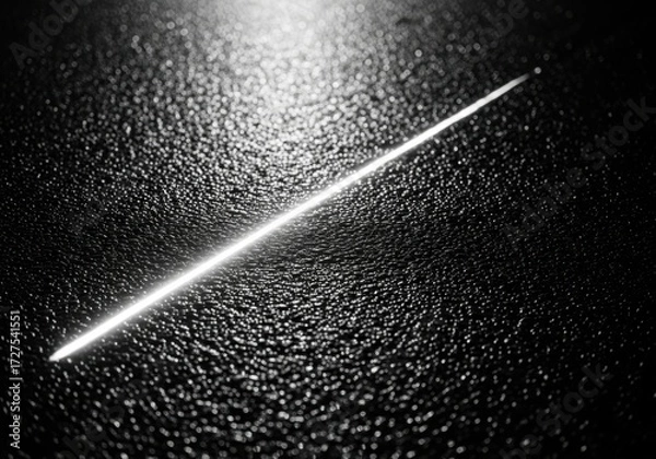 Fototapeta A single bright white line diagonally across a dark textured surface