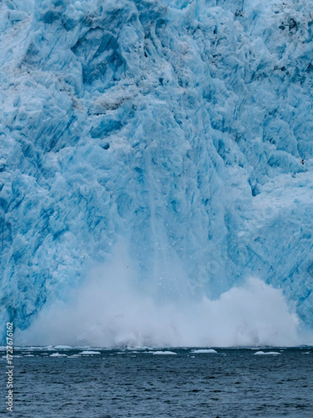 Fototapeta Capturing the explosion of water as ice sheets calve off the Aialak Glacier