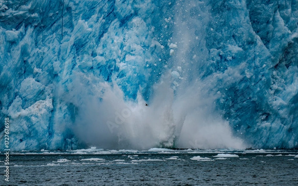 Fototapeta Capturing the explosion of water as ice sheets calve off the Aialak Glacier