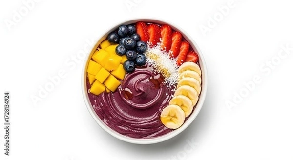 Fototapeta Colorful acai bowl topped with banana, strawberries, blueberries, mango and coconut.