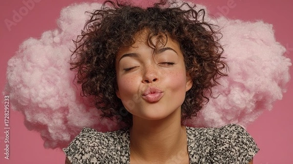 Fototapeta Woman Blowing Kisses on a Cloud Against a Pink Background. Romantic and Playful Gesture in a Soft and Dreamy Setting
