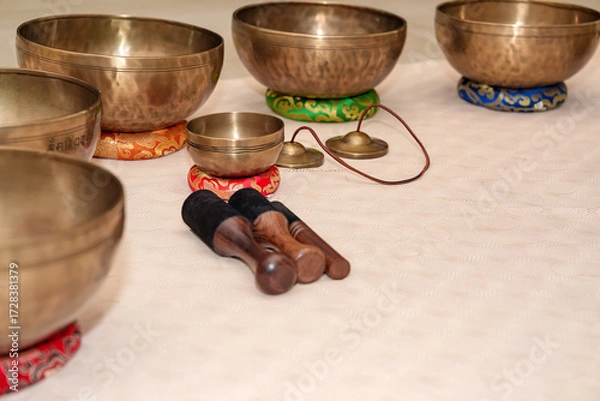 Fototapeta Set of Tibetan singing bowls arranged and ready for relaxation and yoga or meditation practice.