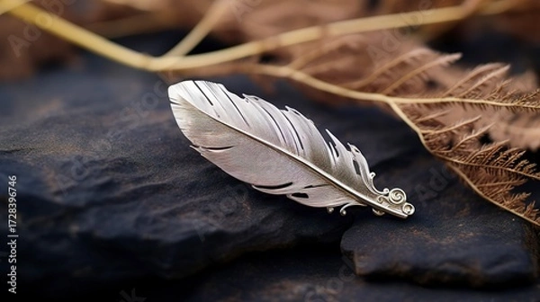 Obraz A photo of a silver feather brooch.
