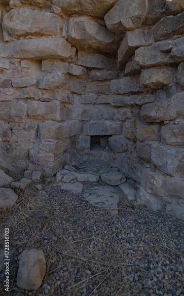 Fototapeta Nuraghe Piscu megalithic stone tower ruins in Suelli, Sardinia, under clear blue sky