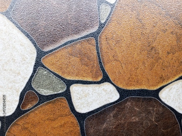 Fototapeta Detailed close-up of decorative stone floor tiles with irregular shapes and natural textures. Ideal for backgrounds, textures, architecture, and design themes.