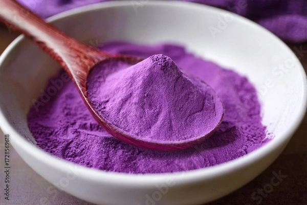 Obraz Close-up of purple sweet potato powder, also known as ube powder,  on a brown wooden spoon in white Japanese-style bowl. Bright and soft natural lighting.  Generated image