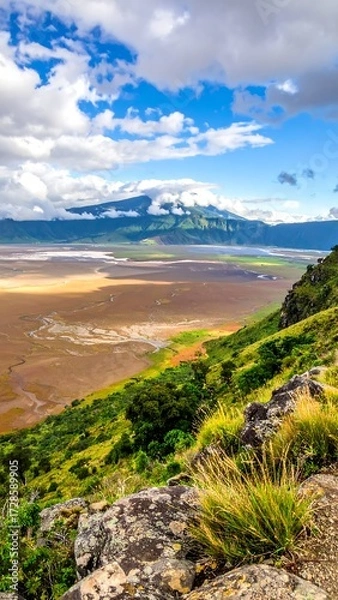 Obraz Panoramic vista of a high-elevation valley, with rocky, grassy slopes and a mountain range in the background
