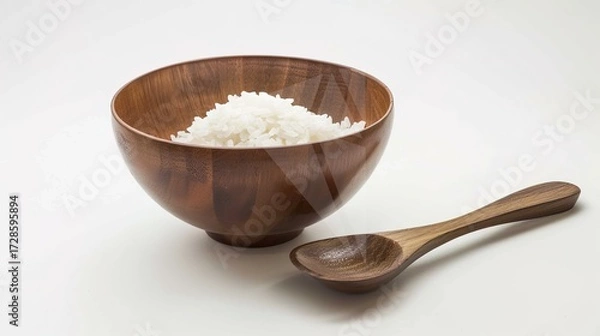Fototapeta Rice, Wooden Spoon, and Bowl – a warm and rustic composition. The natural textures and earthy tones create a cozy, homey kitchen atmosphere.