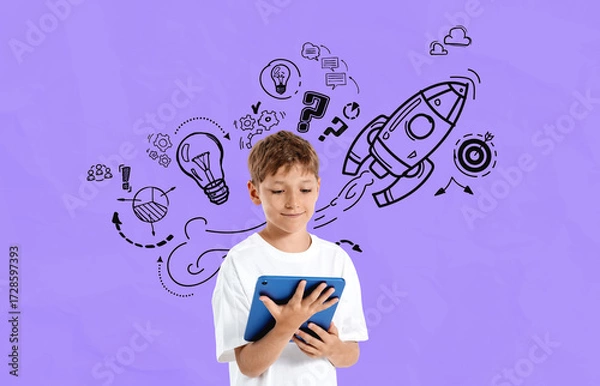 Fototapeta Kid using tablet with creative drawings of rocket, lightbulbs, a