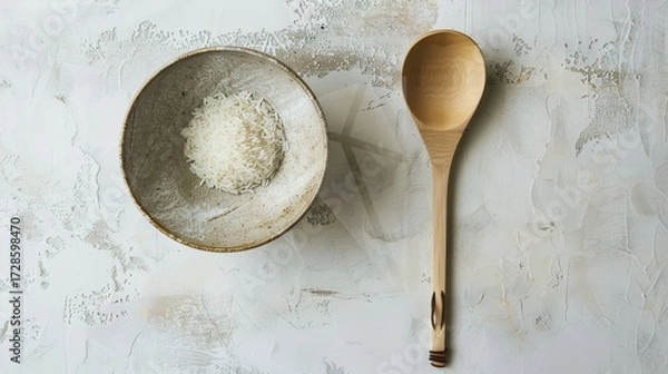 Fototapeta Rice, Wooden Spoon, and Bowl – a warm and rustic composition. The natural textures and earthy tones create a cozy, homey kitchen atmosphere.