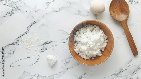 Fototapeta Rice, Wooden Spoon, and Bowl – a warm and rustic composition. The natural textures and earthy tones create a cozy, homey kitchen atmosphere.