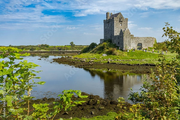 Fototapeta Dunguaire Castle on a sunny summer day, a 16th-century tower house on the southeastern shore of Galway Bay in County Galway, Ireland, near Kinvara
