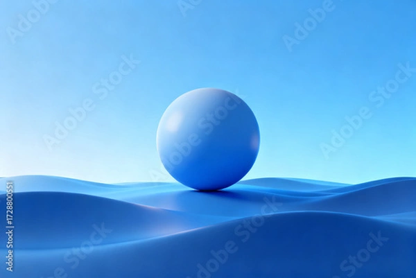 Fototapeta A smooth blue sphere rests on undulating waves under a clear sky
