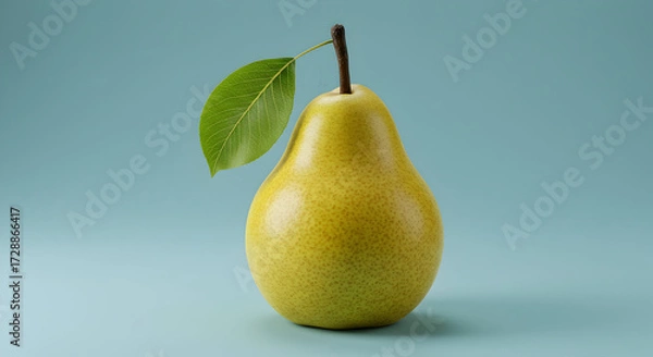 Fototapeta A Bright Yellow Pear with a Fresh Green Leaf on a Clean Blue Background
