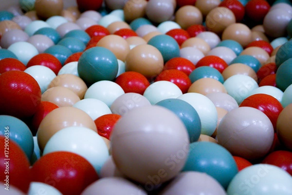 Obraz This photo captures a close-up view of colorful plastic balls in a children’s playground ball pit. The balls come in a variety of soft and vibrant colors such as teal, beige, red, white, light brown.