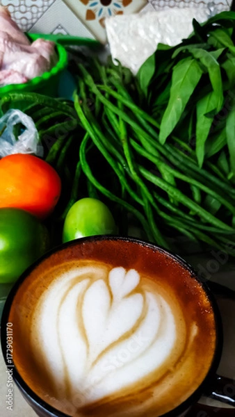 Fototapeta A cup of latte among the vegetables for. Cooking preparation. Household activities.