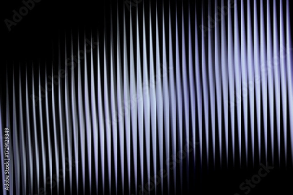 Fototapeta Abstract vertical lines with a subtle blue and white gradient on a dark background