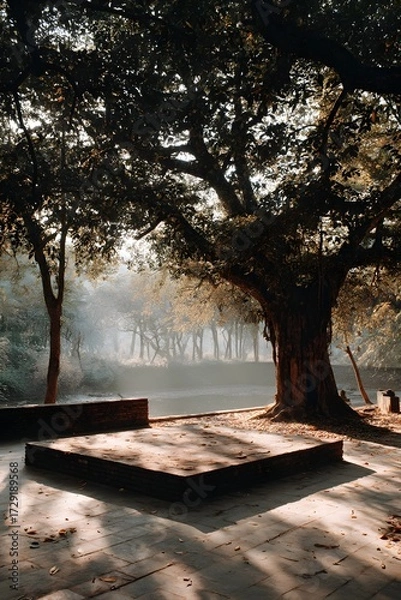 Fototapeta A quiet stone platform beneath a sacred bodhi tree in a sunlit forest clearing. Peaceful, spiritual, and empty—perfect for themes of reflection, mindfulness, or inner awakening.