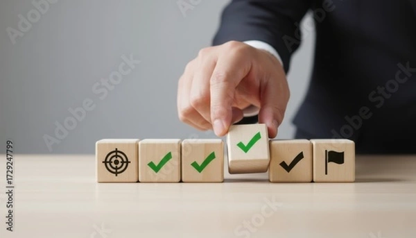 Fototapeta Goal Completion: The hands of a businessman, demonstrating an array of milestones, systematically aligning the wooden blocks, signifying a clear path to ultimate project success
