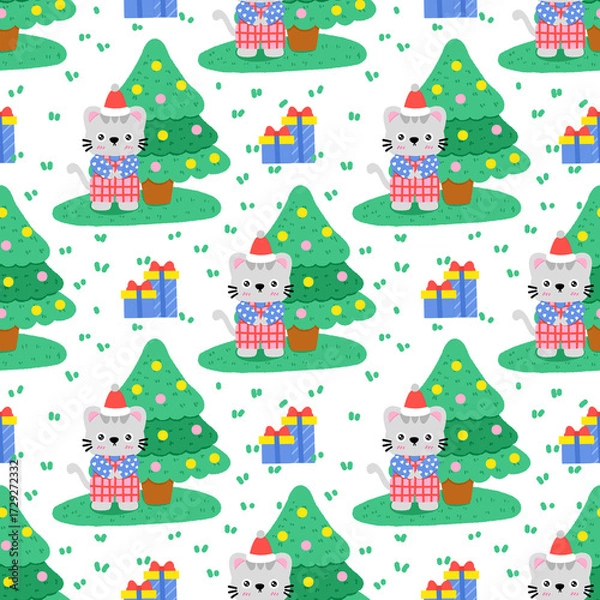 Obraz A cat is sitting in front of a Christmas tree