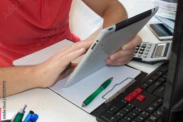 Fototapeta Businessman using a calculator to ipad the numbers. Accountancy, Calculation Concept