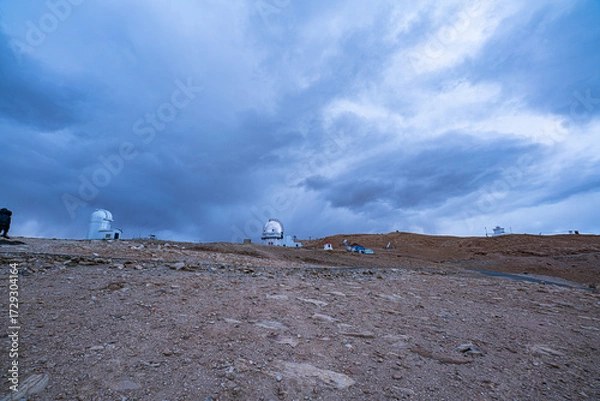 Fototapeta The Indian Astronomical Observatory in Hanle, Ladakh, sits under a vast blue sky, where white clouds drift by. Its setting and solitude create the perfect spot for deep space observation.