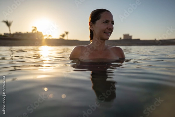 Obraz Young woman relaxing in sea at evening, closeup wide photo, afternoon sunset background