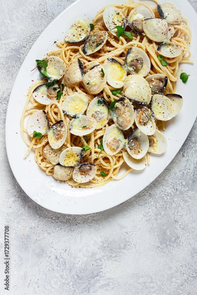Obraz spaghetti with vongole clams, in cream sauce, carbonara, on a white plate, homemade, top view, no people,