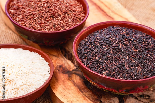 Obraz set of red and black and white rice, in a bowl, on a wooden surface, rustic style, top view