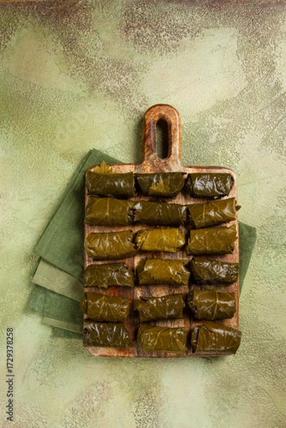 Obraz dolma, minced meat with rice, in grape leaves, minced meat rolls, on a chopping board, top view, no people,