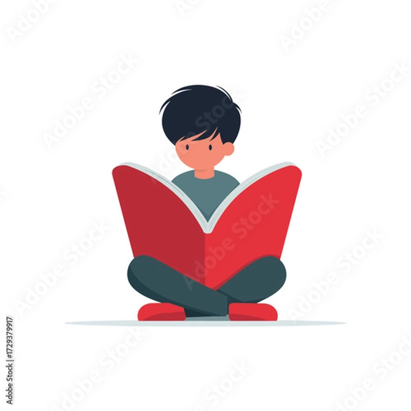 Fototapeta A young boy sits cross-legged, engrossed in reading a large red book, promoting literacy and education.