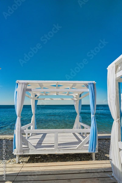 Fototapeta vertical poster with tents for recreation on the seashore, advertising recreation on the seashore in places equipped to minimize the impact on the environment, caring for marine ecosystems
