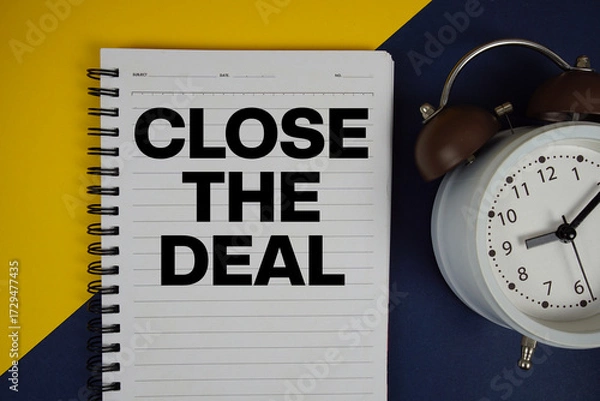 Obraz Close the Deal text written on notepad with alarm clock on yellow background
